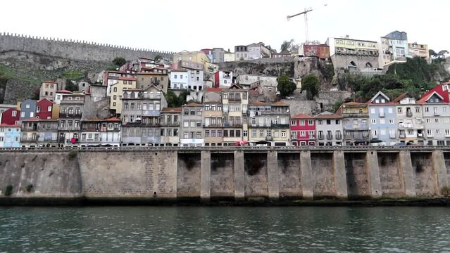 Sliding beautiful landscape view of Porto and Muralha Fernandina from Douro River