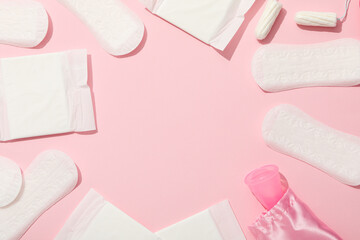 Menstrual feminine hygiene products on a pink background