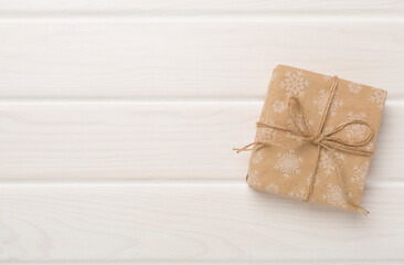 Craft christmas gift boxes on wooden background, top view