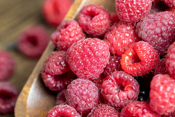 Ripe raspberries on a wooden board