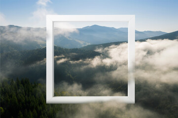 Wooden frame and beautiful mountains with fog in morning