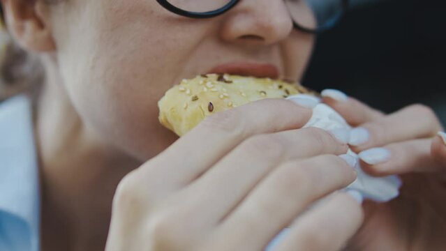Close-up woman eating tasty piece of pizza, enjoying taste fatty unhealthy snack