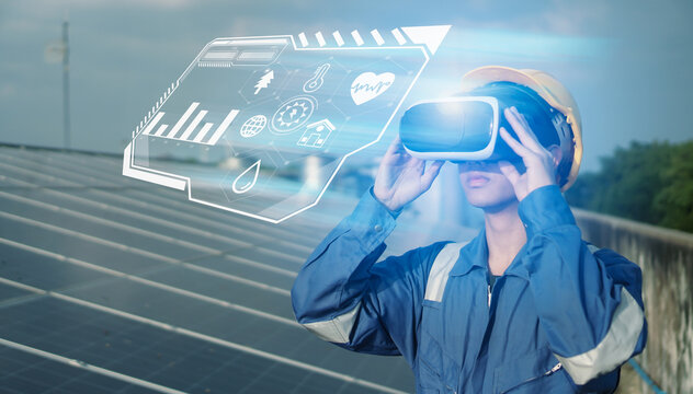 Engineer inspect and check solar cell panel and wearing vr glasses to view solar panel information  renewable energy power factory concept  lowkey lighting.