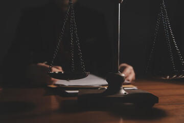 Business and lawyers discussing contract papers with brass scale on desk in office. Law, legal...