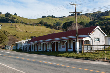 Obraz premium Old red and white wooden Sale Yards building in Devauchelle, Banks Peninsula, New Zealand