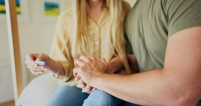 Holding hands, couple in bedroom and positive pregnancy test, joy and excited for future family in home. Surprise, love and man with pregnant woman celebrate good news with ivf results sitting on bed