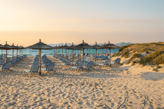 Sunbeds with umbrella on sandy beach of Marmari. The Greek island of Kos