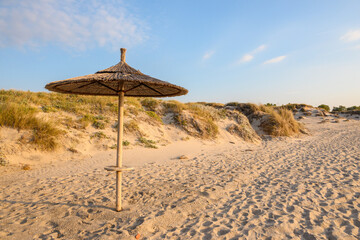 Straw umbrella on sandy beach of Marmari. The Greek island of Kos