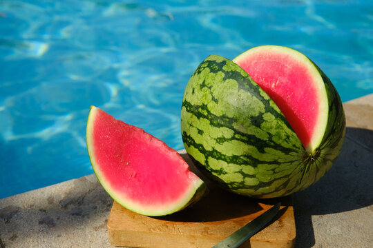 a whole sweet ripe watermelon with one slice