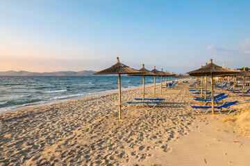 Straw umbrellas on sandy beach of Marmari. The Greek island of Kos