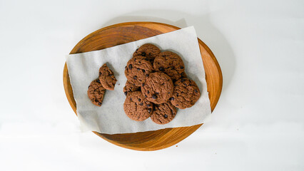 Pile of Delicious Chocolate Chip Cookies on a Wooden Plate. White background