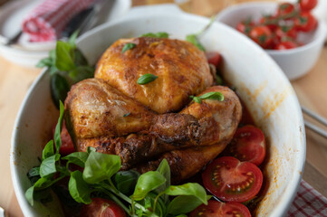 Baked chicken with cherry tomatoes on a table