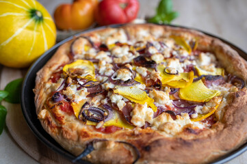 Pizza with feta cheese, salami, pumpkin, onions, tomatoes, homemade food