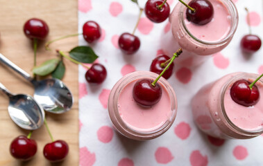 Healthy snack with a homemade yogurt and fresh cherries. Served in jars