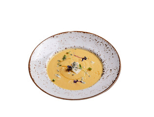 Pumpkin cream soup with mold cheese on a plate, white background