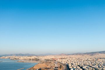 Fototapeta na wymiar Athens Skyline Meets the Blue: City Buildings and Expansive Sky