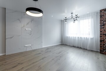 The interior of an empty modern apartment in bright colors immediately after renovation