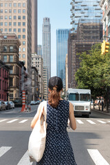 Tourist girl faces New York City, skyscrapers, street of Manhattan, USA