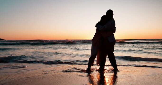Couple, running and hug by beach in sunset, silhouette or game with love, romance or bonding on vacation. Man, woman and outdoor by waves, sea or dusk on holiday, honeymoon or comic together by ocean