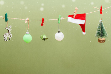 Festive New Year background. Traditional symbols hanging on the thread: fir tree, Christmas balls