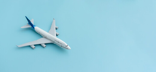 A plane miniature isolated on blue background, after some edits.