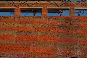 Brick wall, cracked plaster, cracks, texture for mock up. Rustic old red surface. Empty background