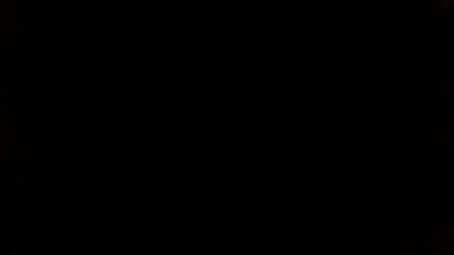 Fireball explosion towards to camera. Fire flame isolated on black background. Shockwave loop animation 4k. Cinematic hell burst digital special effect. Moment of detonation. Dark technology backdrop