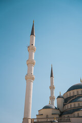 Fototapeta na wymiar Ankara Kocatepe Mosque minaret from below in sunny weather with blue sky