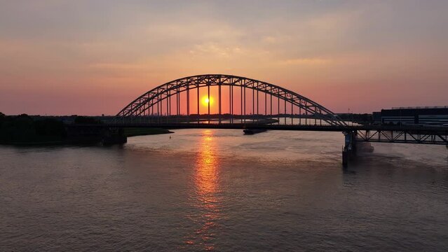 orange sun rising above the River Noord and the Hendrik ido Ambacht bridge