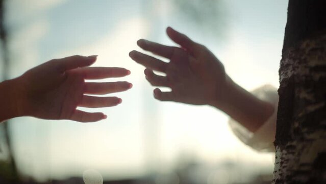The hands of two people tend to touch one another, emotional love, togetherness, human relation, separation concept 