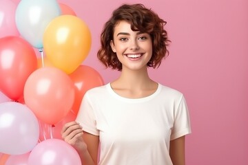 Fototapeta na wymiar female wearing white tshirt with balloons in background for mock up