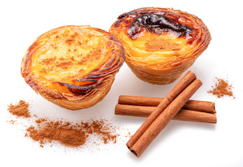 Pastel de nata tarts and cinnamon sticks isolated on white background.