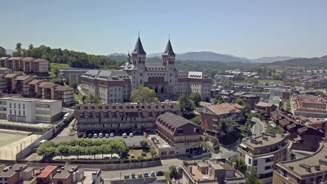 Aerial shot floating towards Elizbarrutiko Seminarioa, in San Sebastian, Spain near Parque de Serafin Baroja.