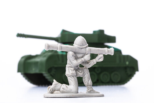 Plastic soldier with rocket launcher aiming at a tank