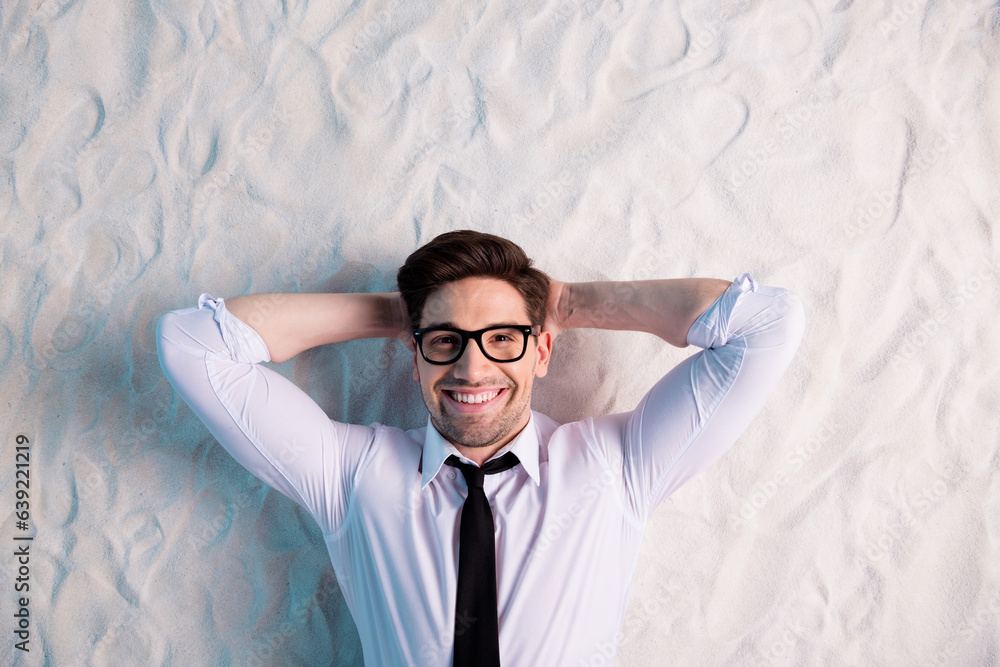 Sticker Top above angle view photo of employee guy marketer lying on sand enjoying summer vacation isolated