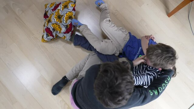 Family Feud - Brothers Engaged in Heated Floor Wrestling. Sibling Showdown of Brothers Wrestling and Arguing on the Floor