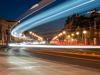 View of the night streets of Berlin and the light trails left by cars. Night European city.