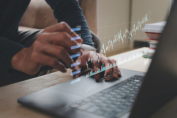 investment and finance concept, businessman holding virtual trading graph and blurred light on hand, stock market, profits and business growth.