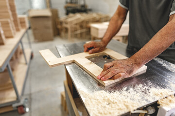 Unrecognizable man carpenter making wooden furniture in workshop