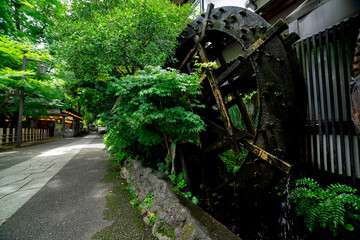 A historic wooden wheel on the water surface in Tokyo wide shot