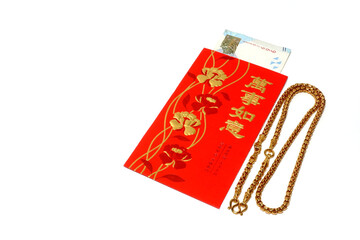 Close-up of red envelopes with money and gold necklace,Popular gift during the festive season,Chinese new year festival