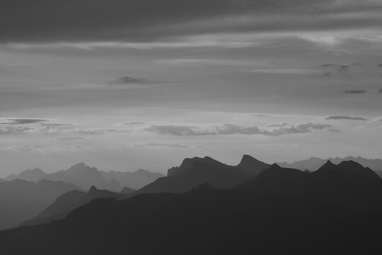 Black and white image of mountain ranges and valleys in the Bernese Oberland seen from Niesen Kulm.