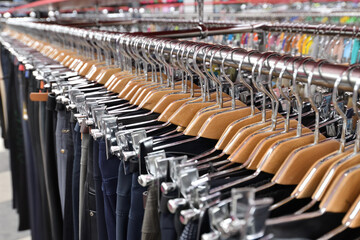Fototapeta premium Men's trousers hang in a row in a store