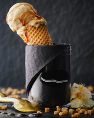Caramel ice cream presentation with ice cream cone in glass bowl