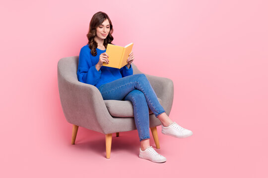 Full size portrait of gorgeous intelligent girl sit comfort chair read book empty space isolated on pink color background