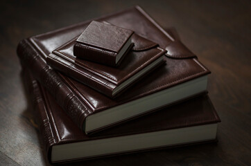 Wedding photobooks in brown leather binding. Wedding photo book, album family album. Photo books with embossing and a cover of genuine leather. Services of a professional photographer and designer.