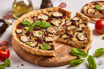 Quiche open tart pie with eggplant, sundried tomatoes and chicken meat. Savory taste. 