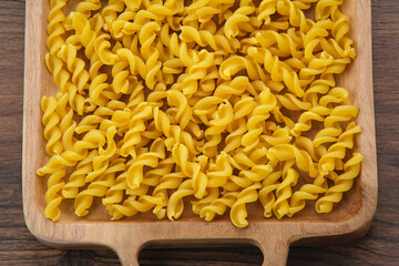 Raw Macaroni pasta, textured background
