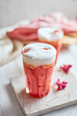 Thai style iced pink milk.Cold sweet drink Red Grenadien Sugar Syrup mix with milk and iced cube in glass