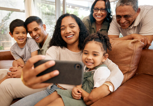Big family, selfie and grandparents with children on sofa for holiday, love and relax together at home. Interracial people, mother and father with kids smile on couch for profile picture photography